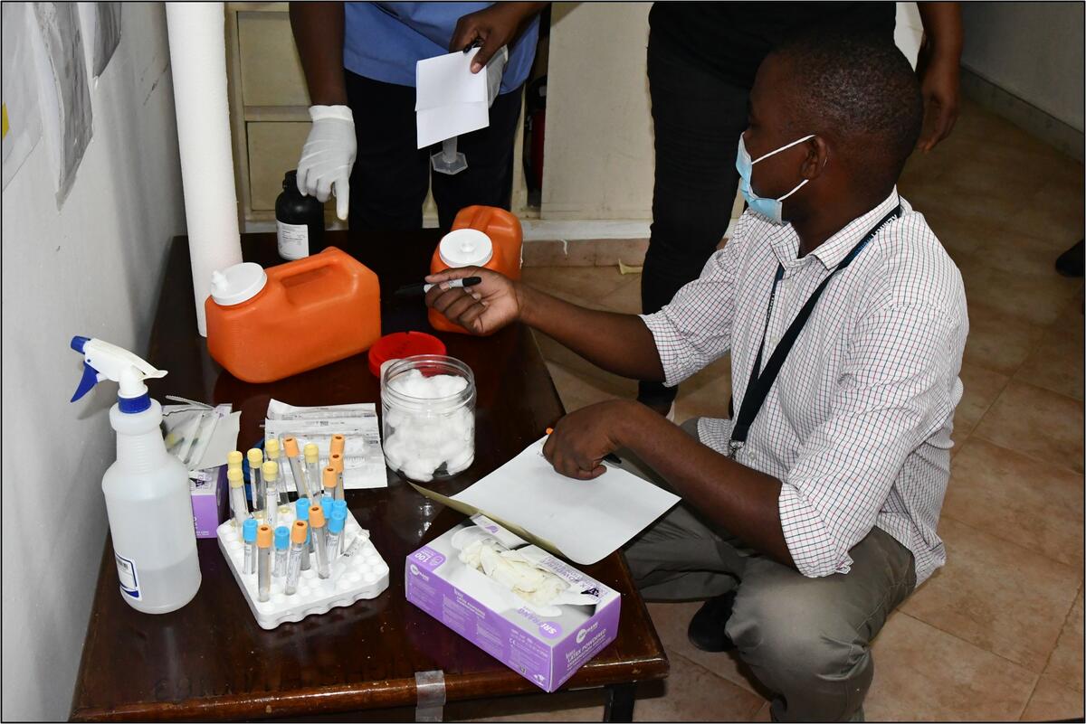  KEMRI-Wellcome medical officer organising participant blood and urine samples for pharmacokinetic analysis.