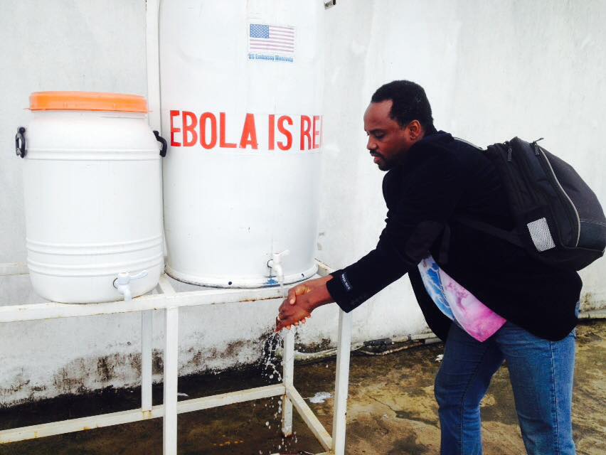 Through our research work at EpiAFRIC, we evaluated the African Union's support to Ebola in West Africa. In this photo,washing my hands with bleach water at Roberts International Airport Monrovia, 2015