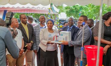 Hon. Ummy Mwalimu (MP) and Minister of Health in Tanzania handing over medical equipment to the heads of the relevant Councils on behalf of each facility. Photo Credit: UDOM