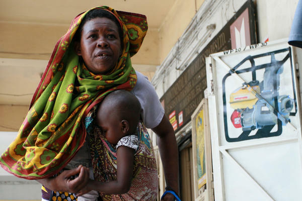 Dar es Salaam, Tanzania - Woman with an infant in a sling.