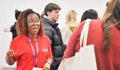 Photo of a current student advising a prospective student on an Open Day