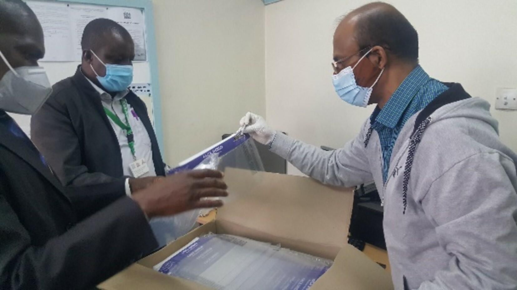 A team of LSTM and Technical Quality subcommittee at National Ministry of Health inspect sample face shields from a supplier for quality assurance. 