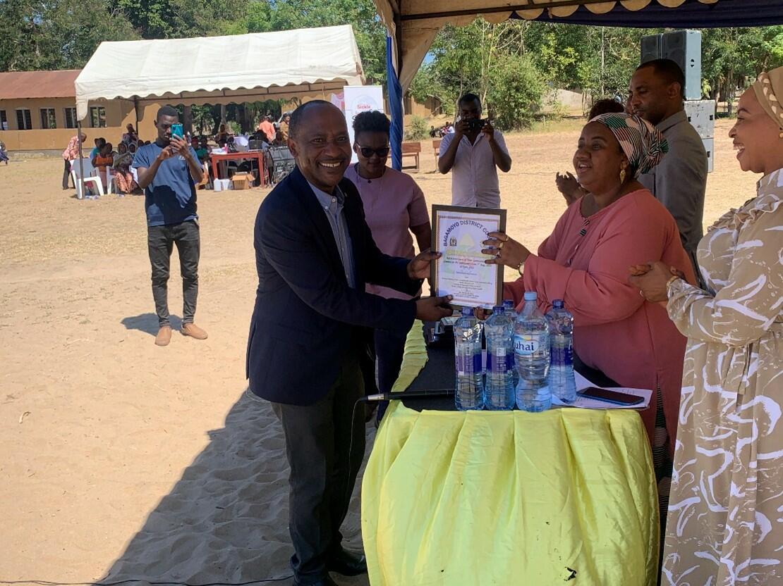 Prof. Mfinanga was receiving appreciation certificate from Hon. Zainabu Abdallah, Bagamoyo DC Prof. Mfinanga was receiving appreciation certificate from Hon. Zainabu Abdallah, Bagamoyo DC