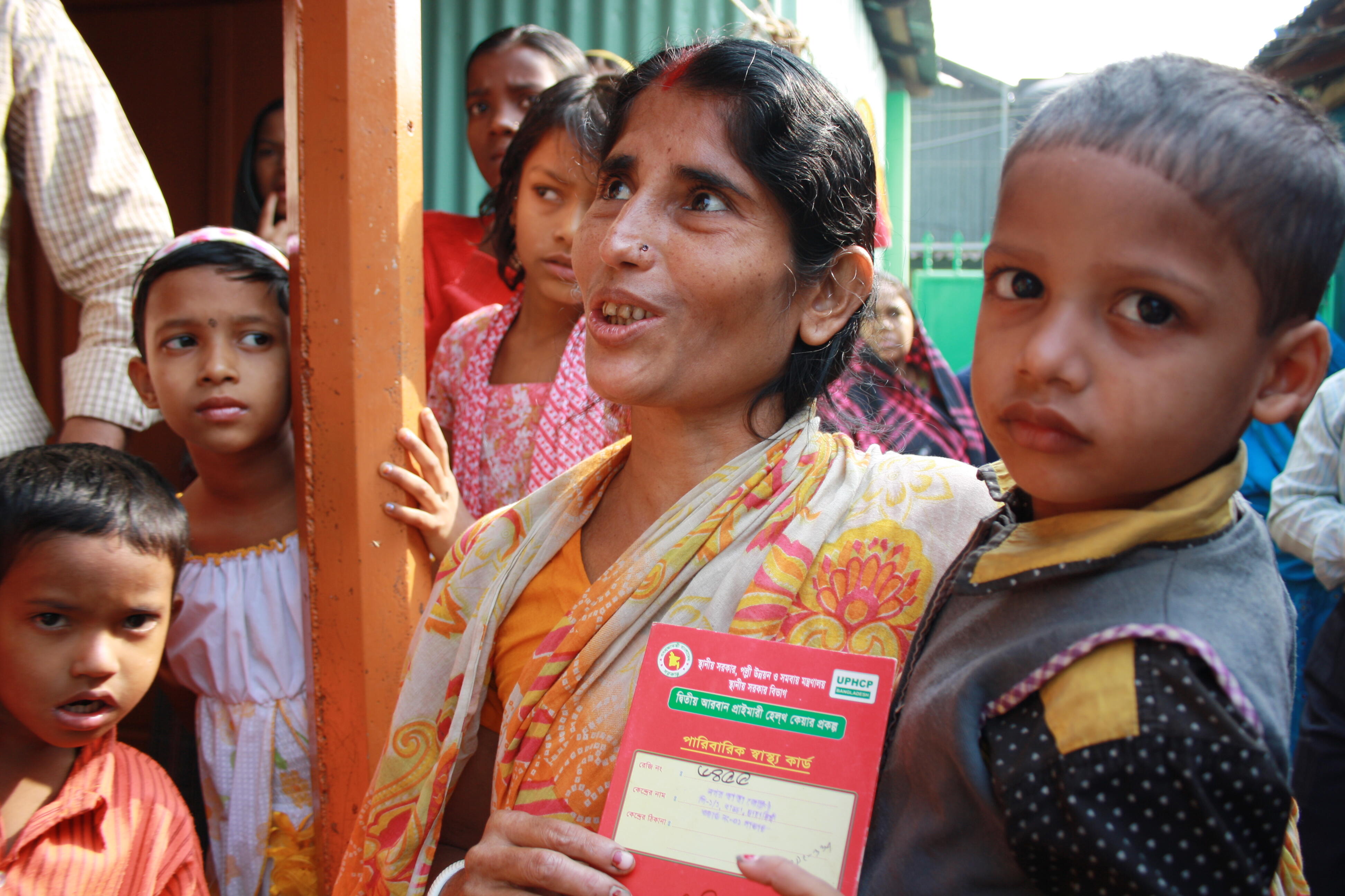 A woman with her 'red health card', which allows her to access government health services in the Korail slum, Dhaka, Bangladesh. Photo: Lucy Milmo/DFID A woman with her 'red health card', which allows her to access government health services in the Korail slum, Dhaka, Bangladesh. Photo: Lucy Milmo/DFID