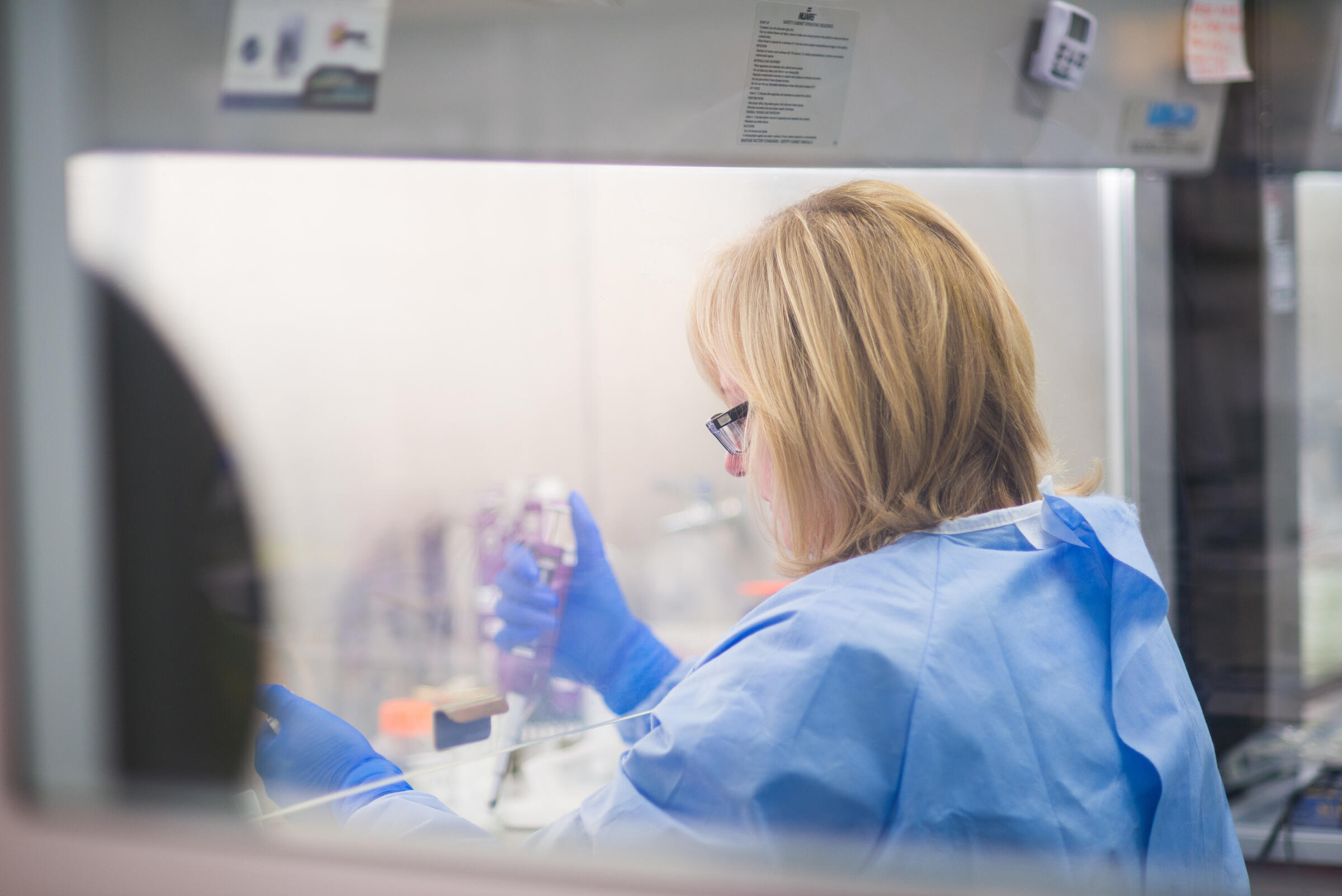 Containment Level 3 laboratories have played a critical role in the COVID effort Female scientist working in high-security laboratory