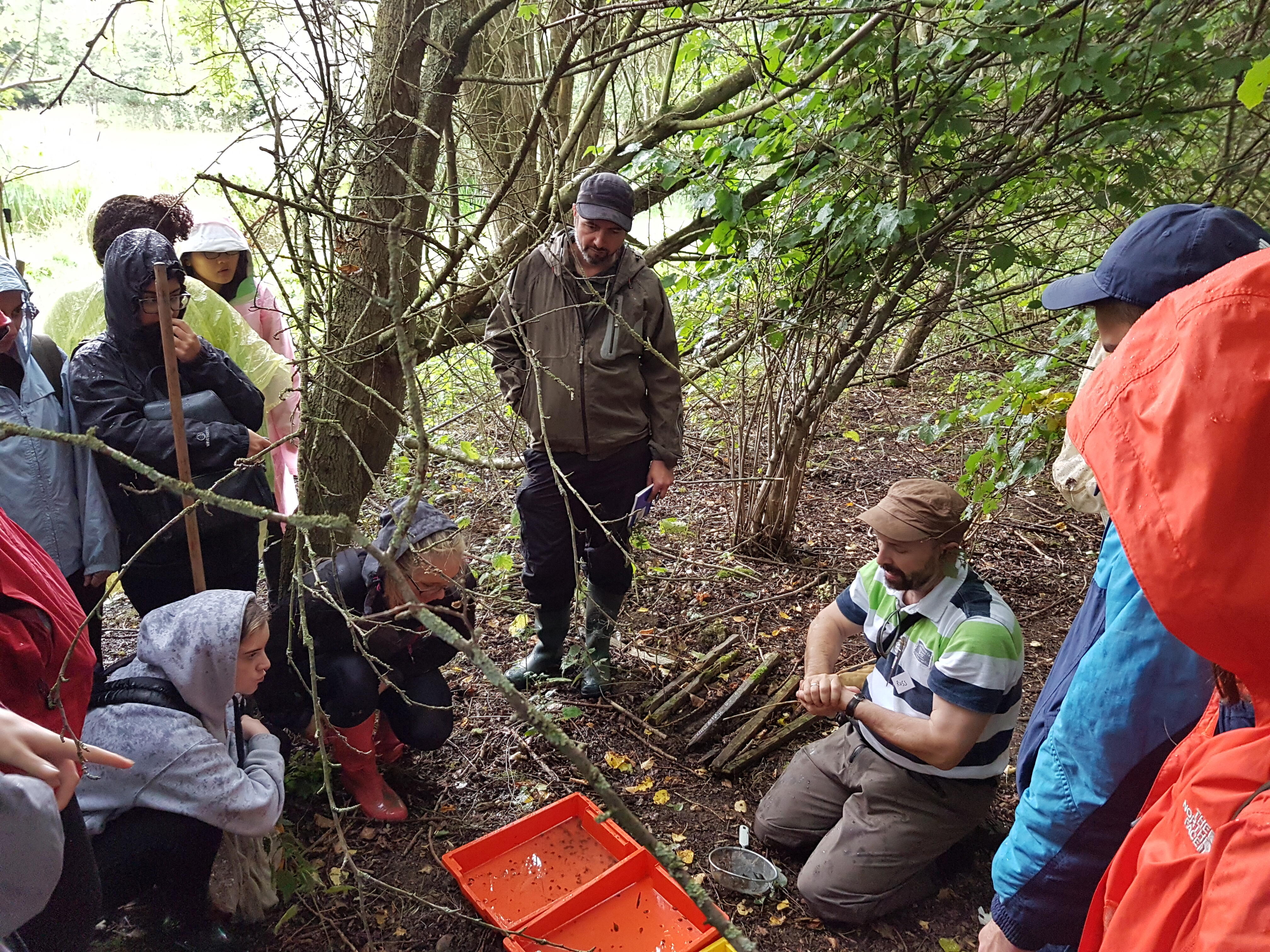 Professor Stothard (seated) teaching fresh water sampling to MSc students Professor Stothard (seated) teaching fresh water sampling to MSc students