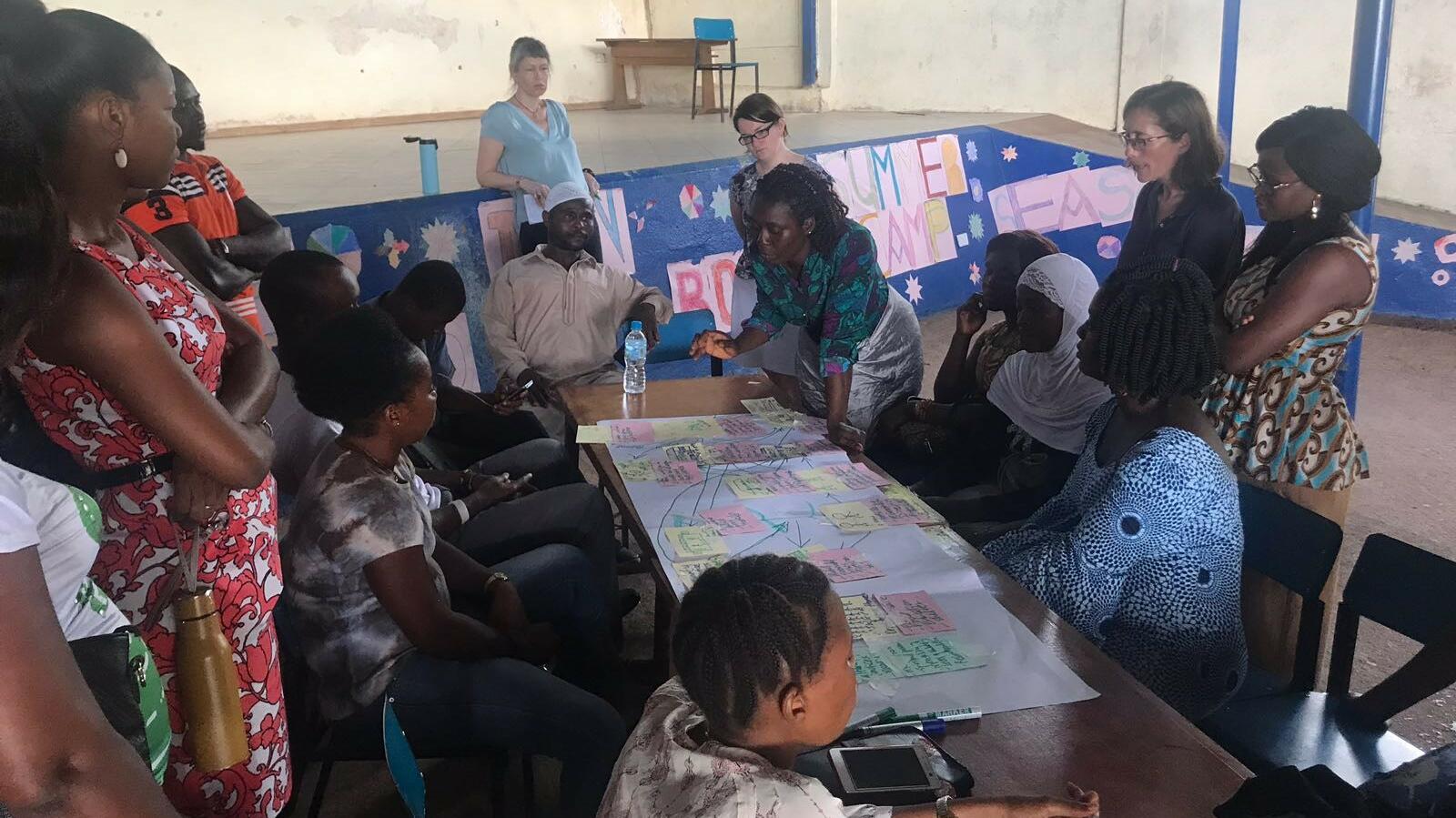 College of Medical and Allied Health Sciences (CoMAHS) team facilitating participatory discussion on non-communicable diseases with residents in Dwarzak informal settlement, Freetown, Sierra Leone. Image copyright: Haja Wurie, College of Medical and Allied Health Sciences (CoMAHS), Sierra Leone. College of Medical and Allied Health Sciences (CoMAHS) team facilitating participatory discussion on non-communicable diseases with residents in Dwarzak informal settlement, Freetown, Sierra Leone. Image copyright: Haja Wurie, College of Medical and Allied Health Sciences (CoMAHS), Sierra Leone.