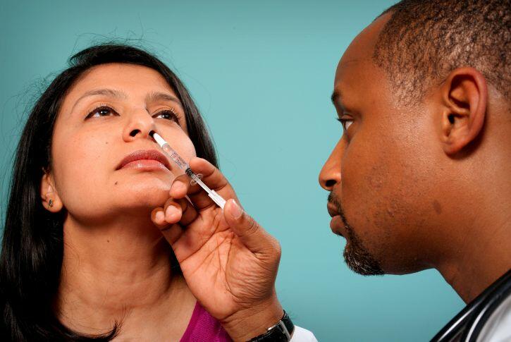 Doctor with nasal spray vaccine Doctor with nasal spray vaccine