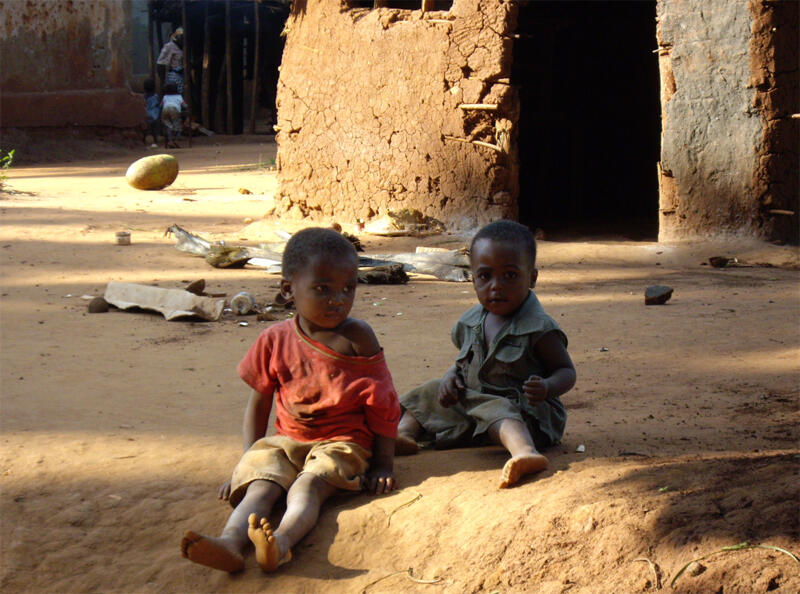 Two children sitting in the dust