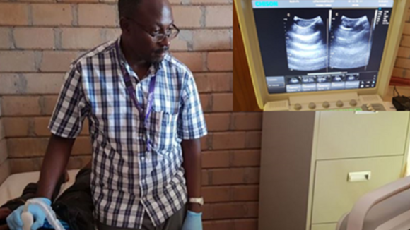 Dr Seke carrying out an ultrasonography relieving a small hydrocele