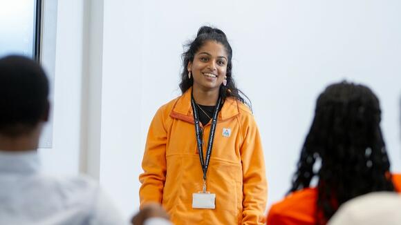 Photo of a a presenter at an LSTM Open Event