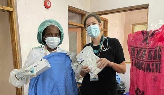 Sister Magombo (left), Lead Nurse and Dr Rachael Burke, PhD researcher and clinician, at Zomba Central Hospital receiving PPE purchased with Bump It Forward donations.