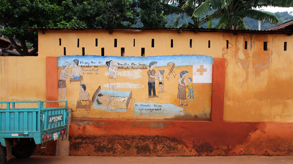 Painted health advice against HIV illness at a wall on a side road between Lomé and Kpalimé near Assahoun in Togo, West Africa.