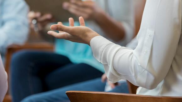 Image of a hand during a group therapy session